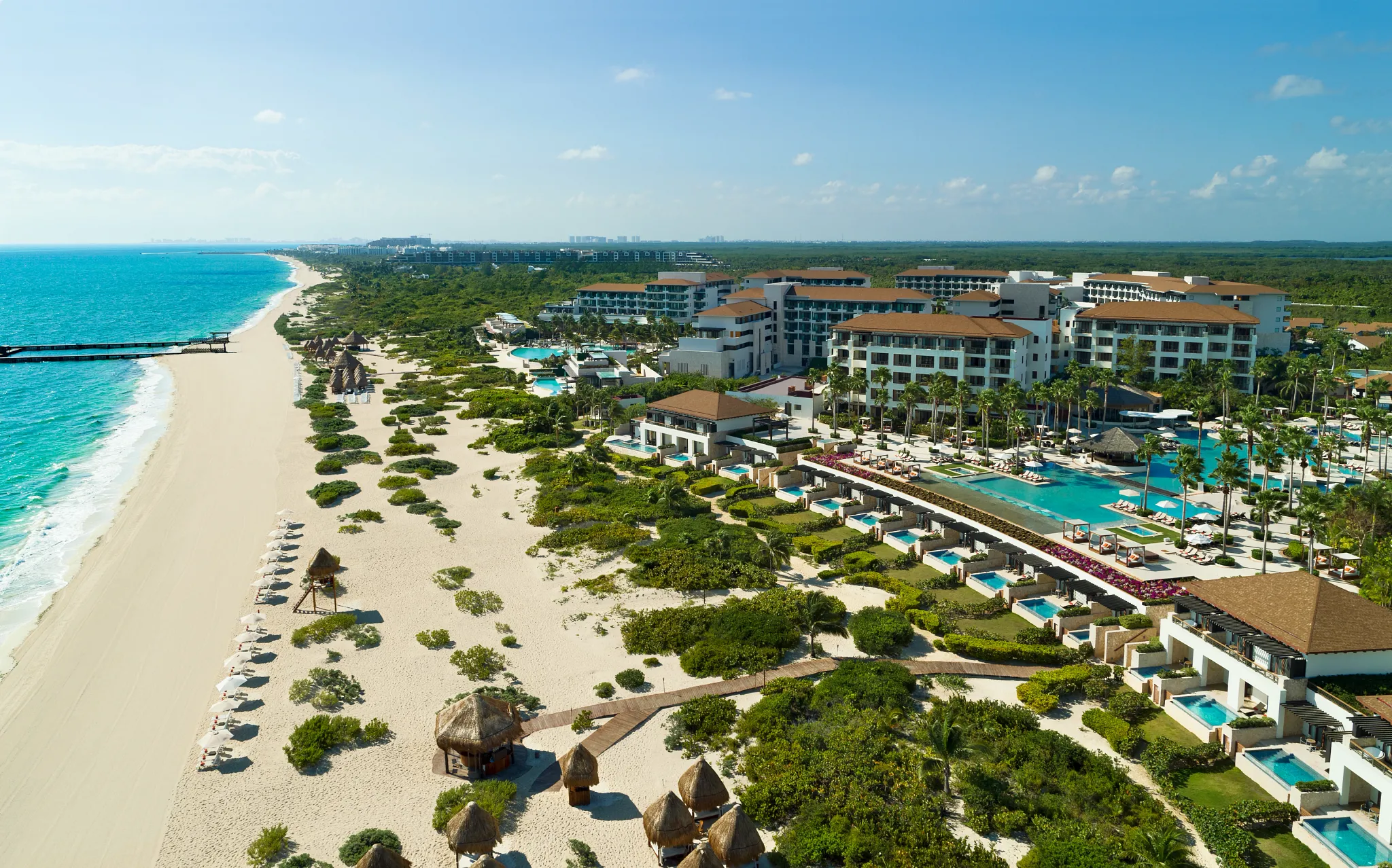 Aerial view of Dreams Playa Mujeres Resort with beachfront, pools, and white sand coastline in Cancun.