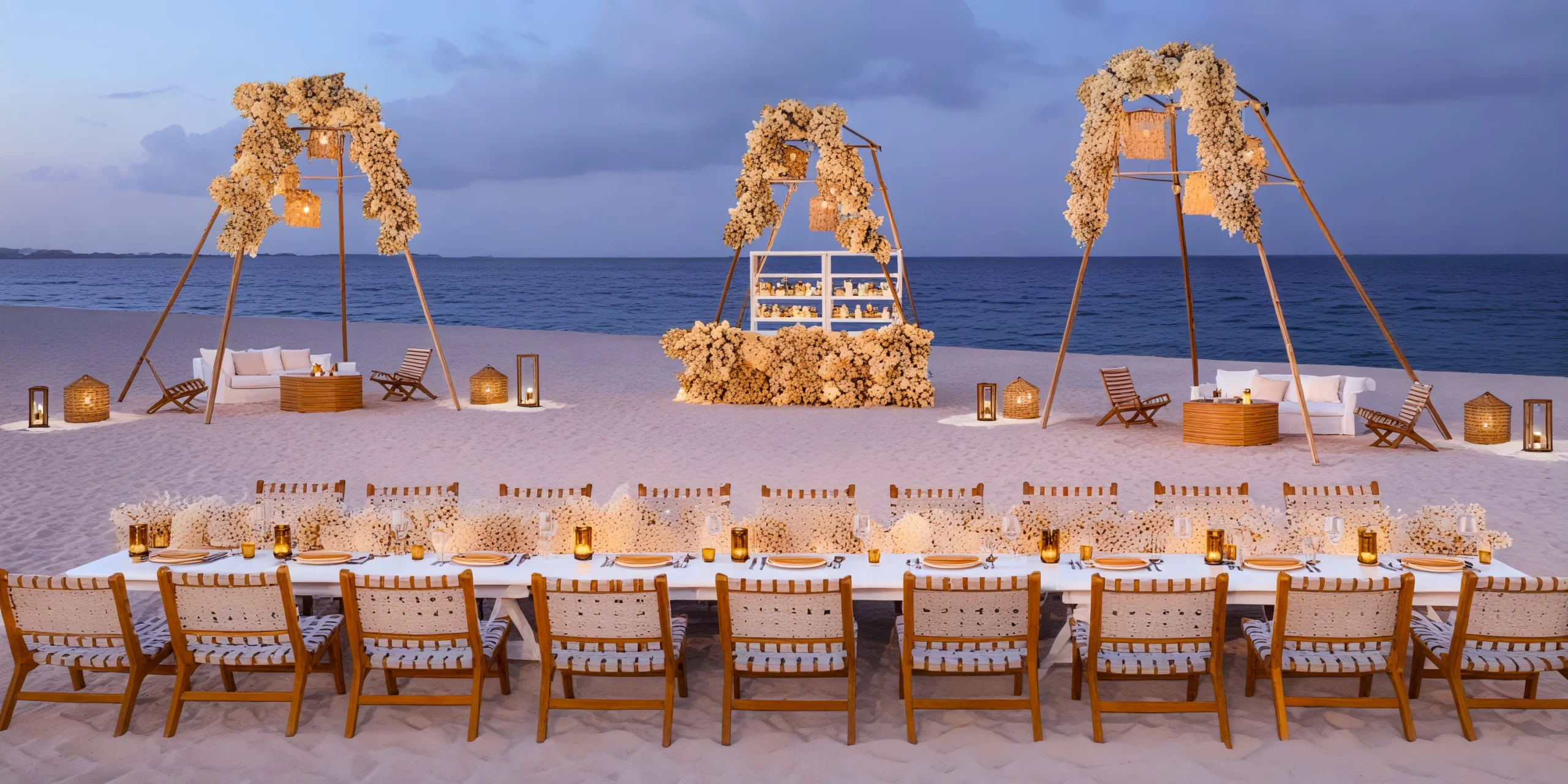 Beachfront wedding reception setup with floral arches at Dreams Playa Mujeres Golf & Spa Resort