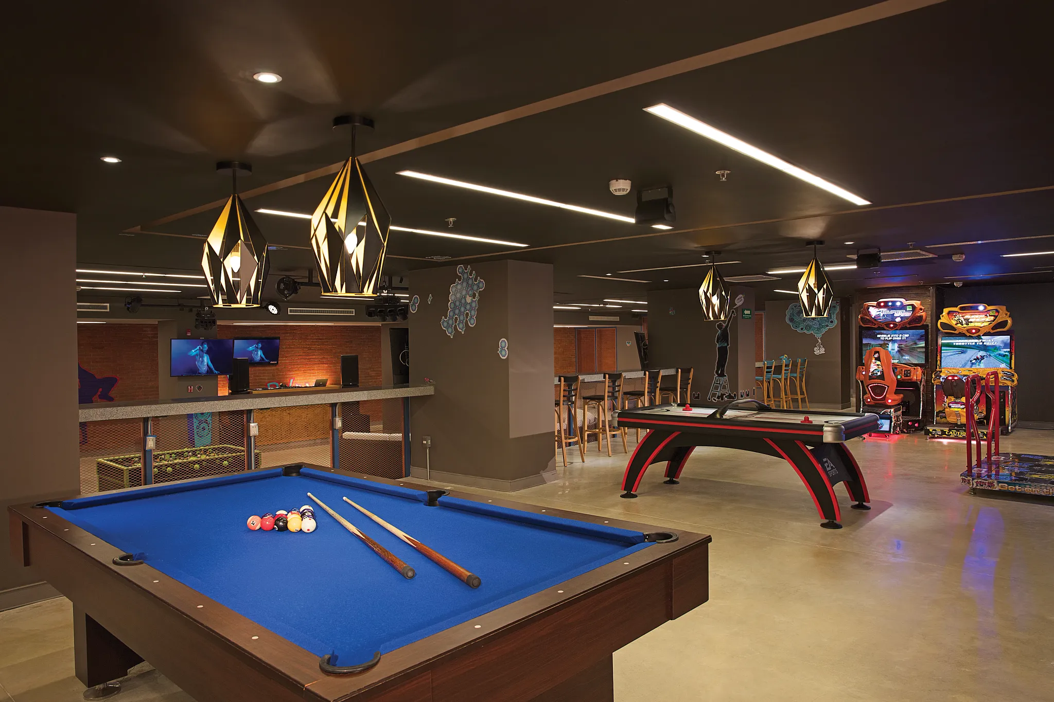 Teen entertainment zone with pool tables and arcade games at Dreams Playa Mujeres Resort.