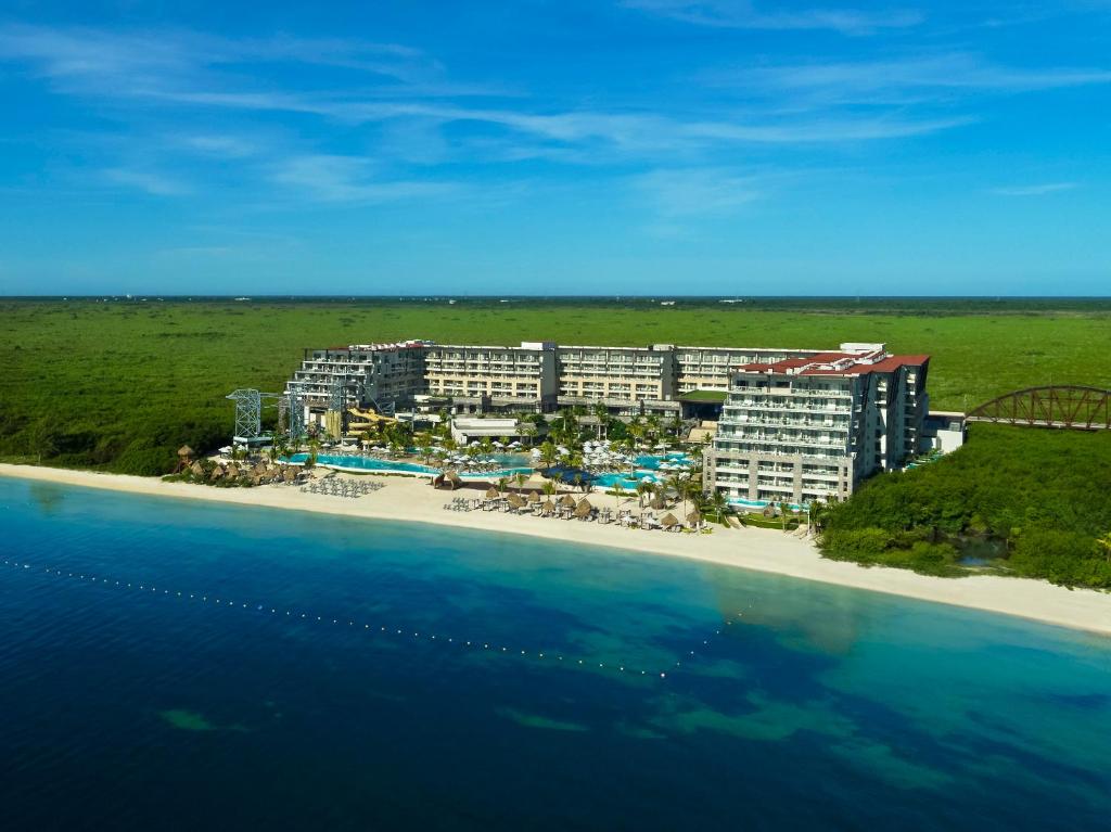 Dreams Natura Resort and Spa all-inclusive beachfront resort with water slides and tropical surroundings near Cancun.