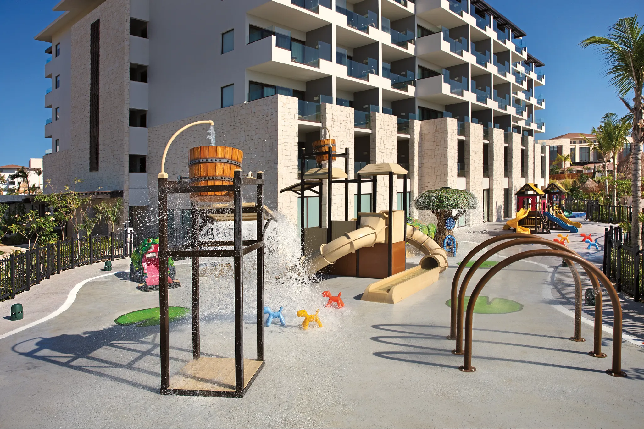 Children’s splash park with water slides and play structures at Dreams Playa Mujeres Resort.