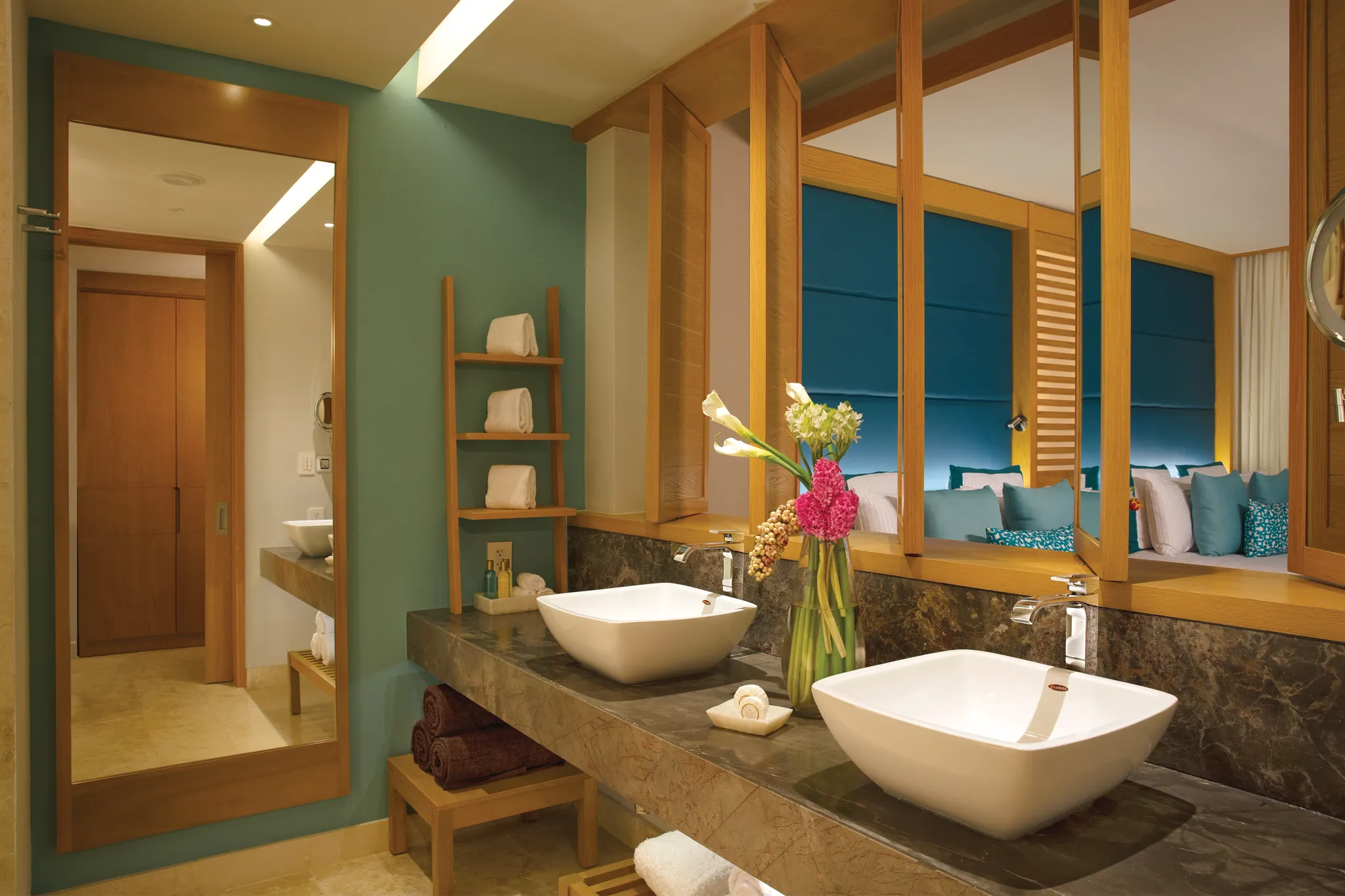 Family Junior Suite Garden View bathroom with double vanities and rain shower at Dreams Playa Mujeres Resort.