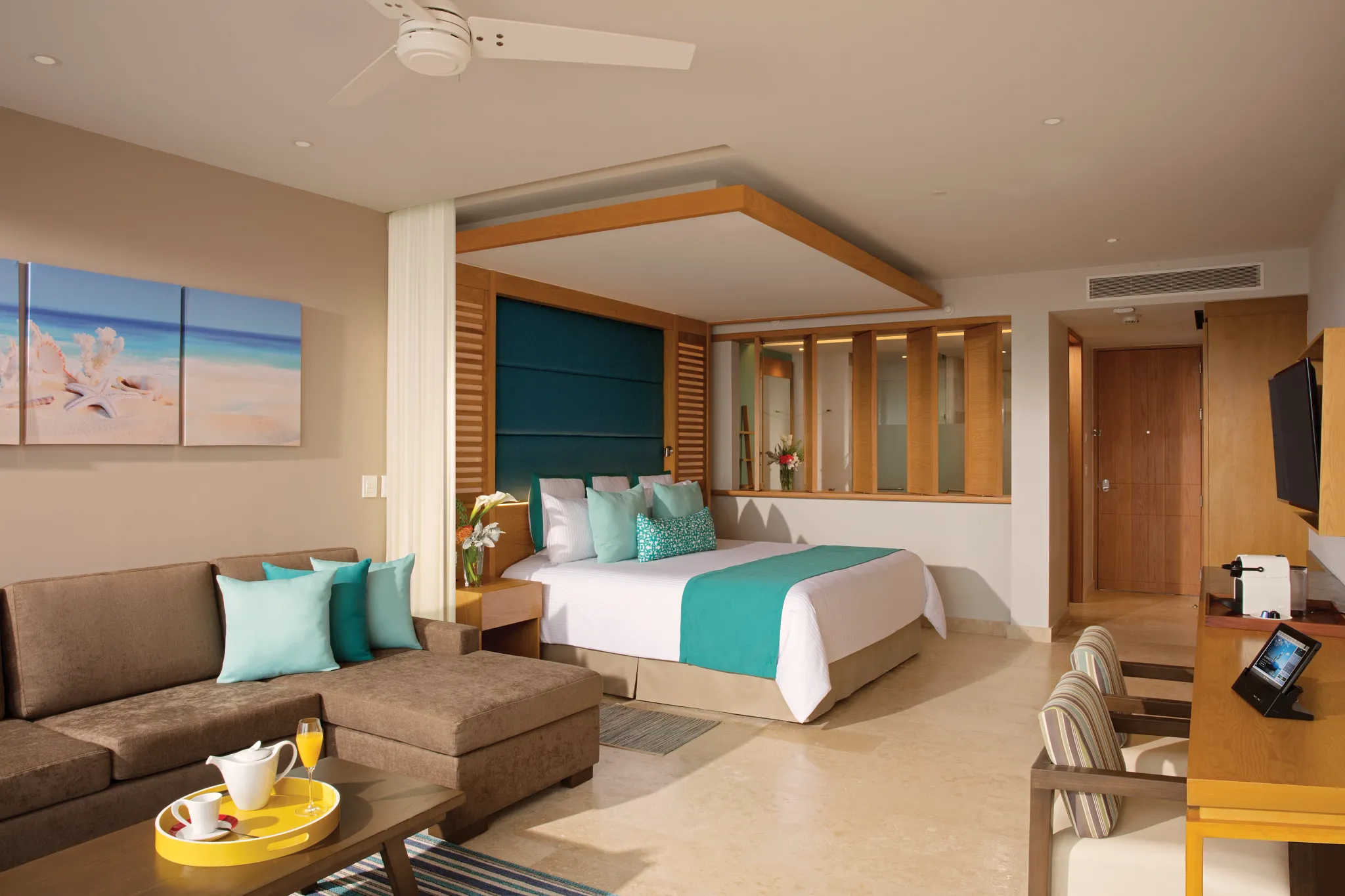 Family Junior Suite Ocean View with king bed and living area at Dreams Playa Mujeres Golf & Spa Resort.
