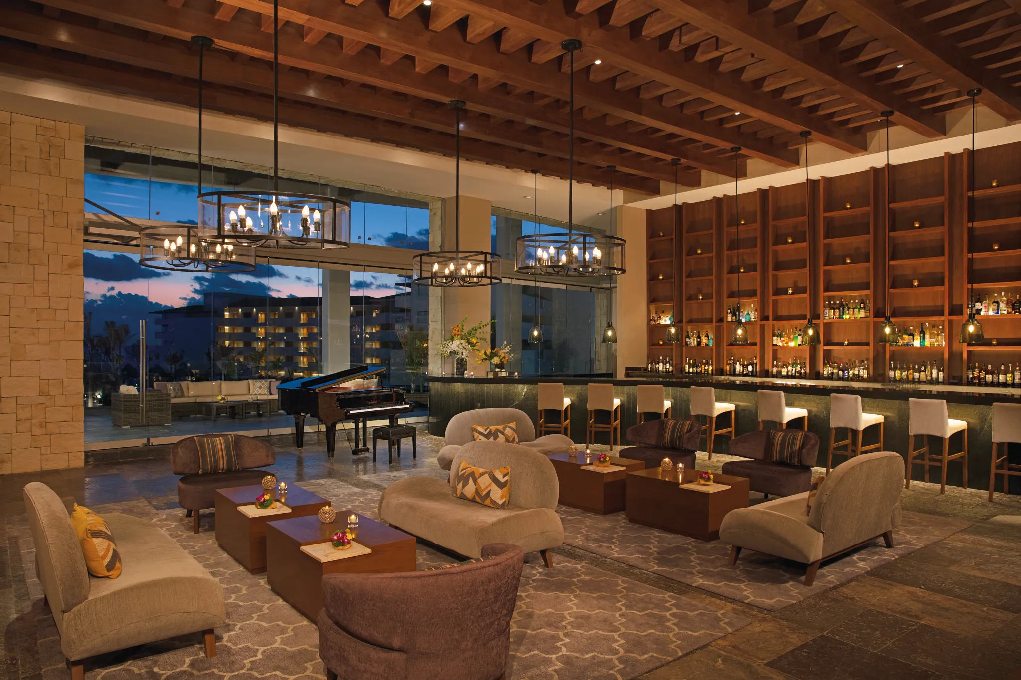 Interlude bar at Dreams Playa Mujeres Golf & Spa Resort featuring a relaxed lobby lounge atmosphere with elegant seating and handcrafted cocktails.