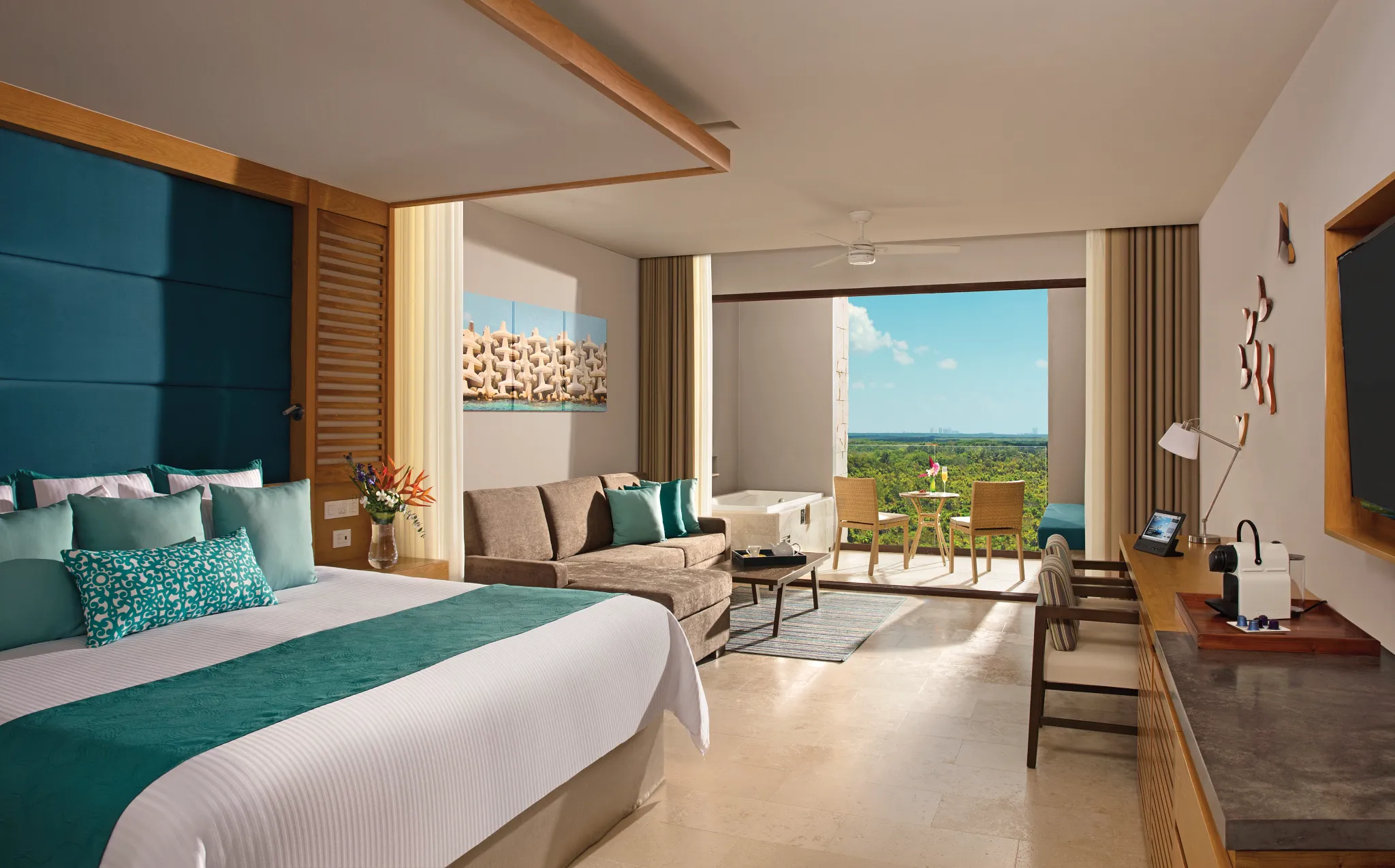 Junior Suite Garden View with king bed, sofa, and terrace with hot tub at Dreams Playa Mujeres Golf & Spa Resort.