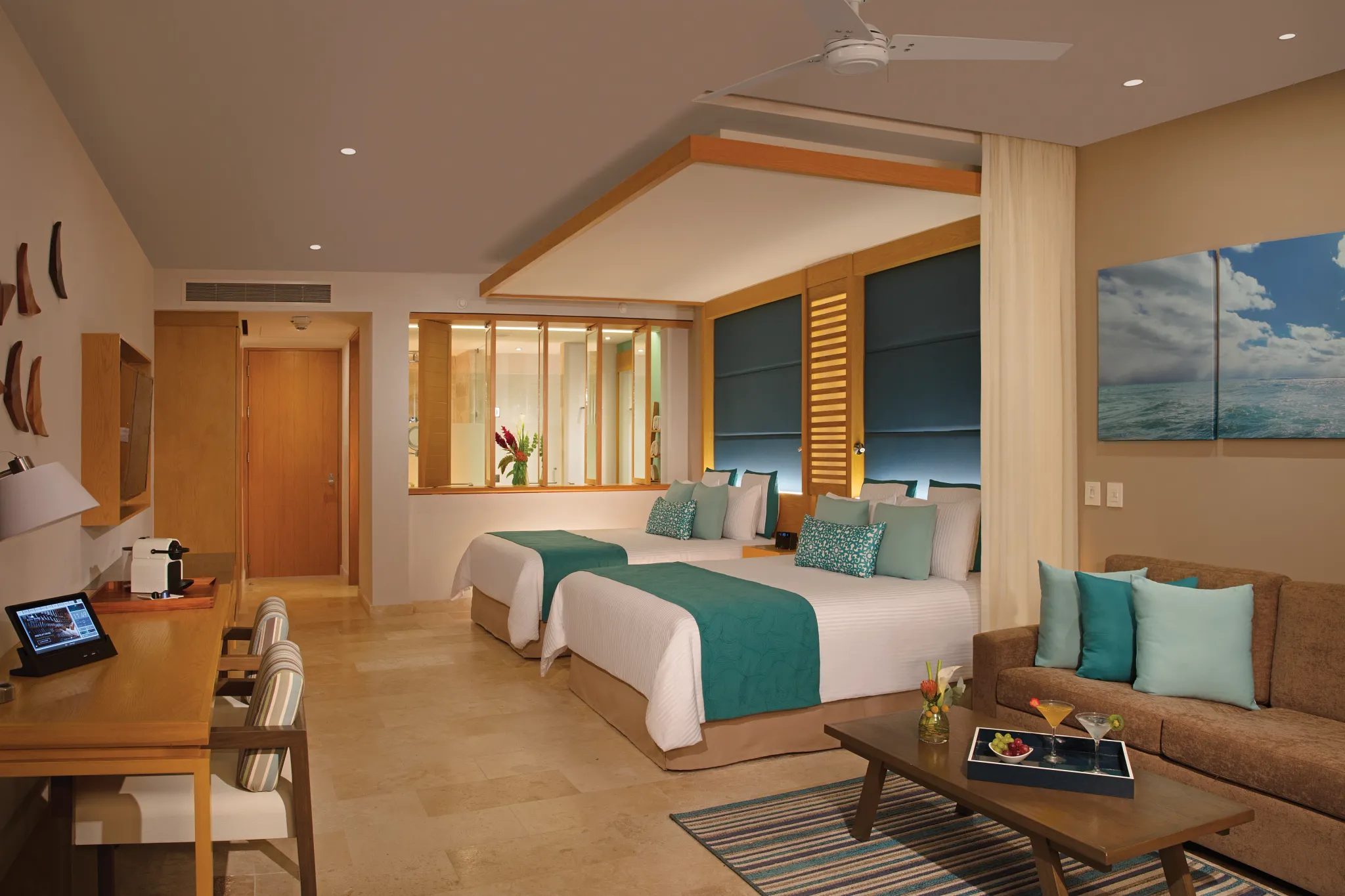 Junior Suite Pool View with two queen beds and sitting area at Dreams Playa Mujeres Golf & Spa Resort.