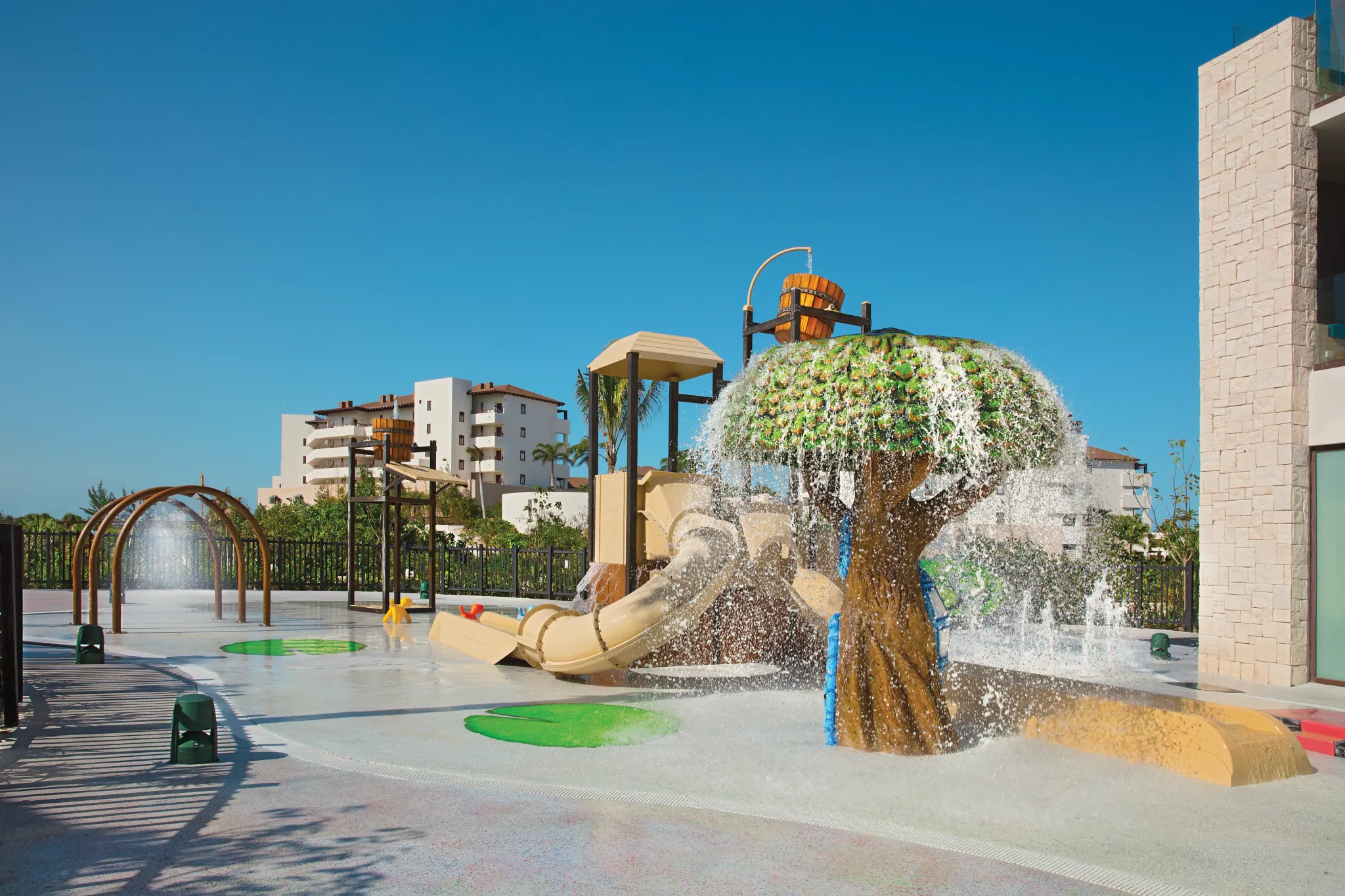 Water playground with slides and splash features for kids at Dreams Playa Mujeres Resort.