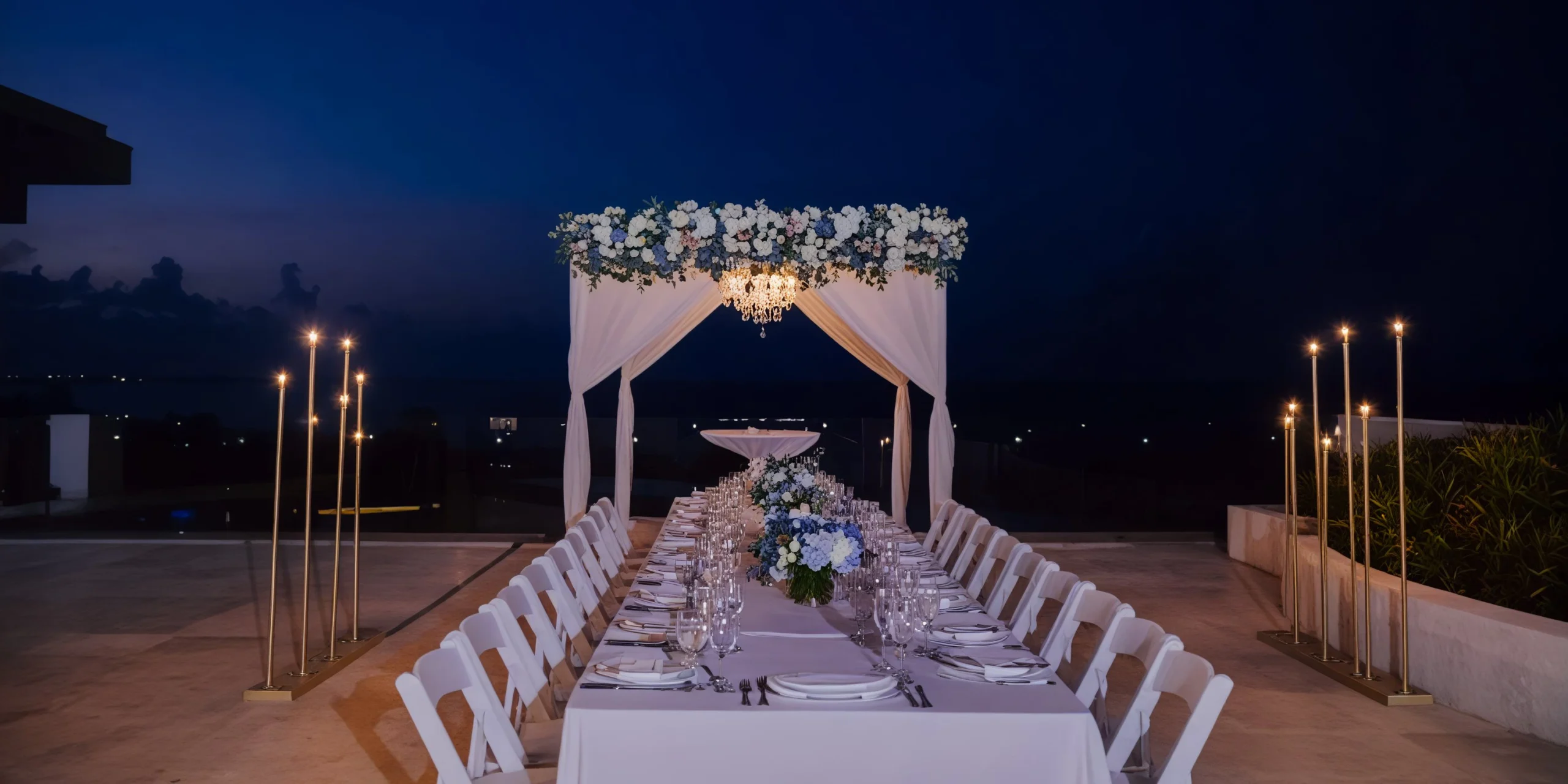 Oceanview terrace reception setup at Paramount Suite with long banquet table at Dreams Playa Mujeres Golf & Spa Resort