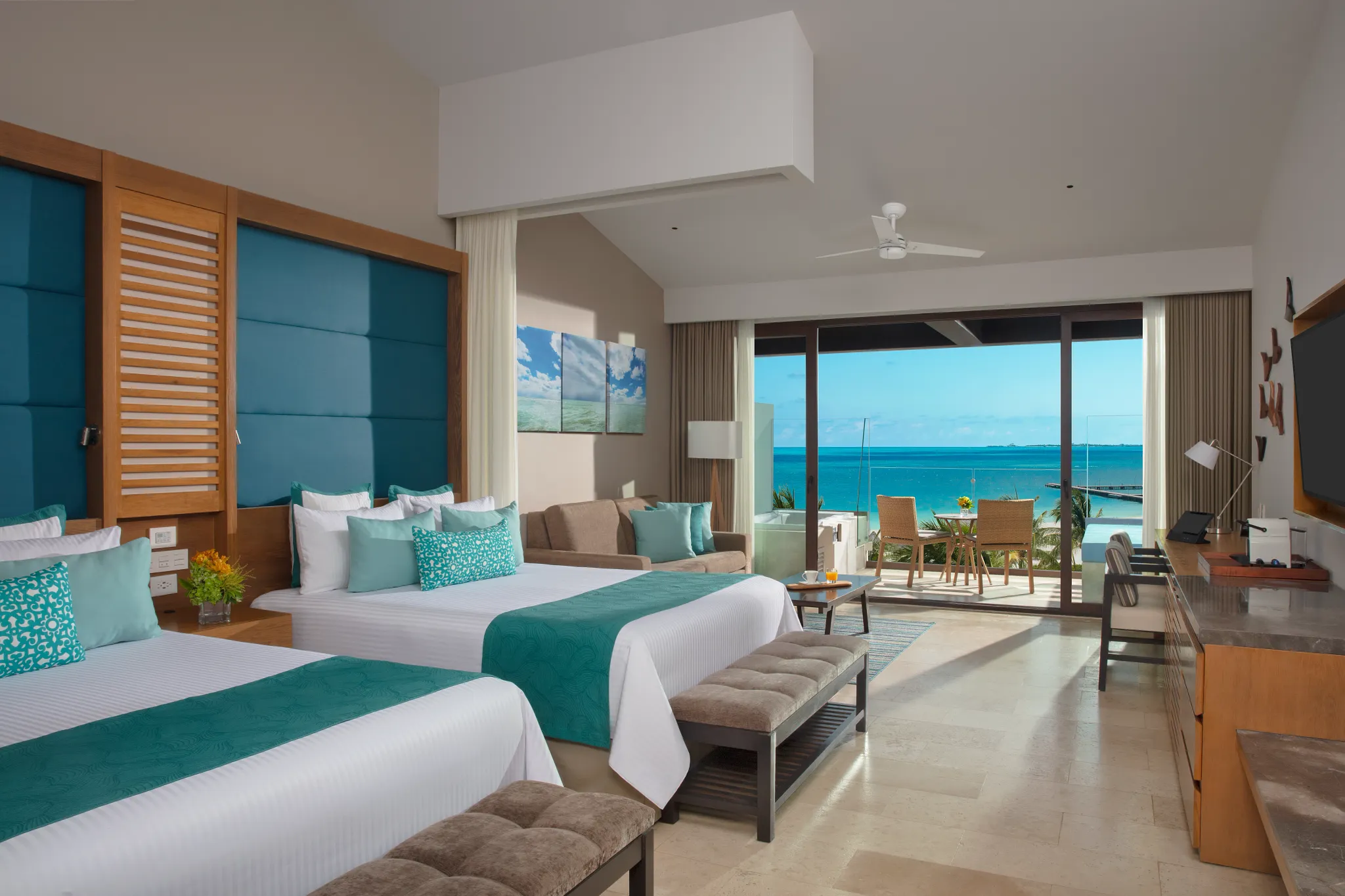 Preferred Club Junior Suite Ocean View with two queen beds and oceanfront terrace at Dreams Playa Mujeres.