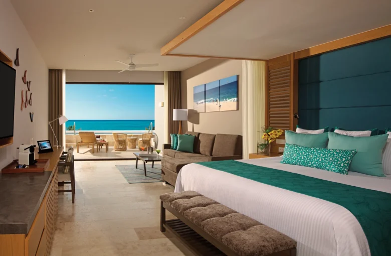 Preferred Club Junior Suite Swim Out Ocean View with king bed and terrace access at Dreams Playa Mujeres.
