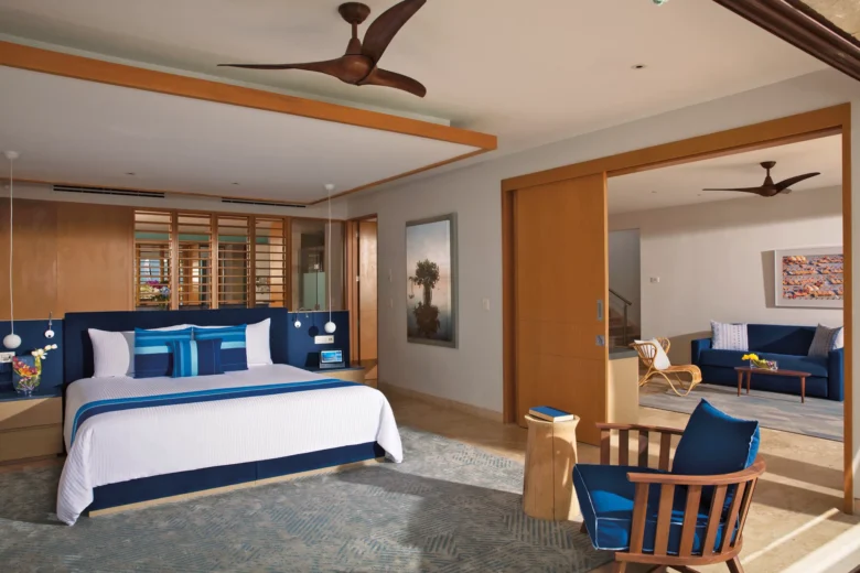 Oceanfront master bedroom with king bed and sitting area at Dreams Playa Mujeres.