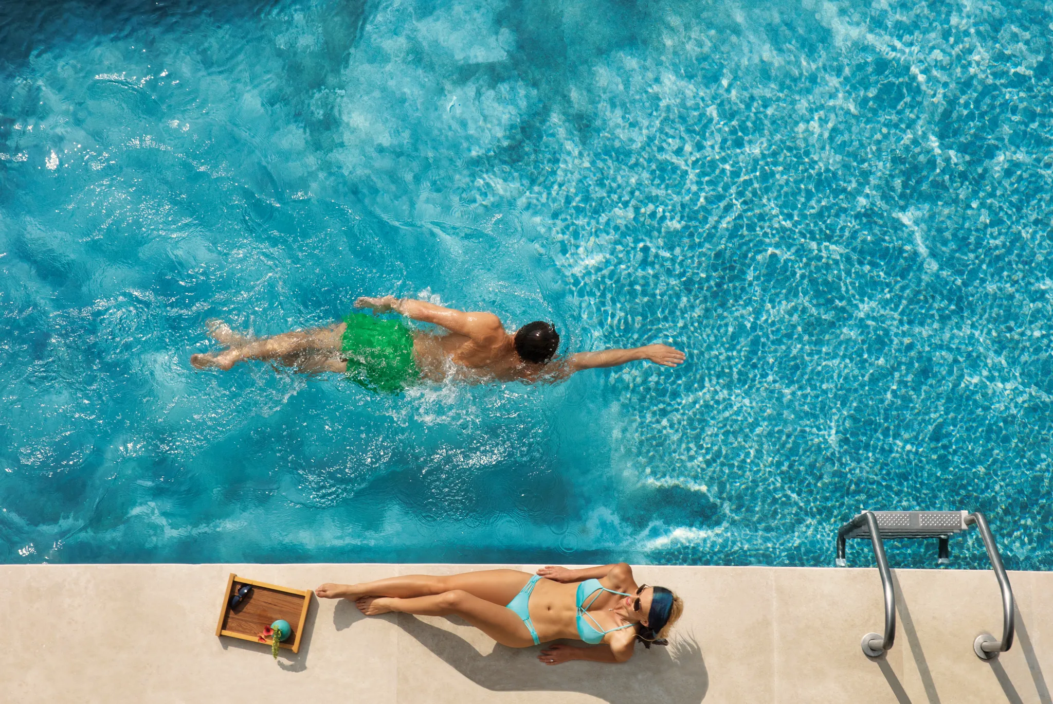 Overhead view of swim-out pool with guest swimming at Dreams Playa Mujeres.