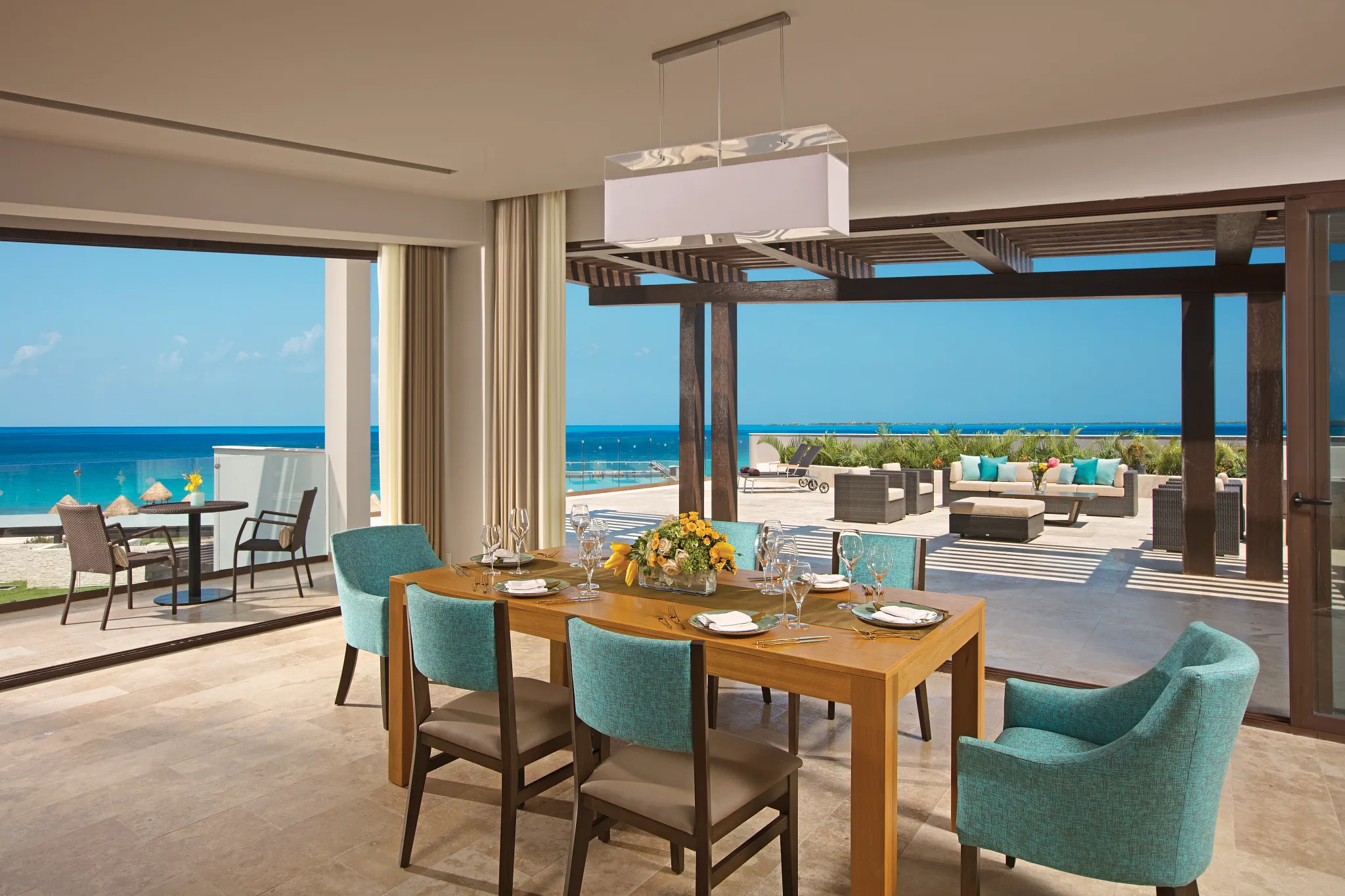 King bedroom with modern decor and seating area in luxury suite.
