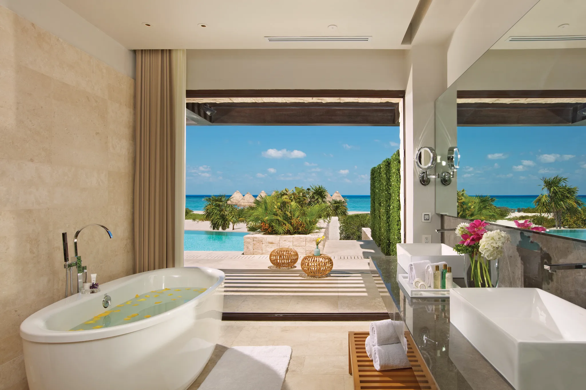 Luxury bathroom with soaking tub and oceanfront terrace view.Luxury bathroom with soaking tub and oceanfront terrace view.Luxury bathroom with soaking tub and oceanfront terrace view.