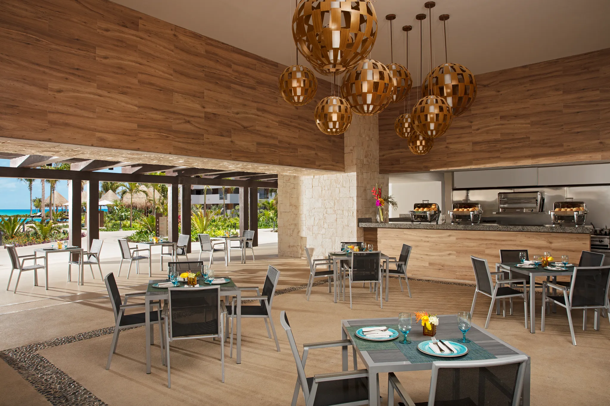 Tides poolside restaurant at Dreams Playa Mujeres Golf & Spa Resort featuring an open-air dining setting with ocean views and a relaxed tropical atmosphere.vv