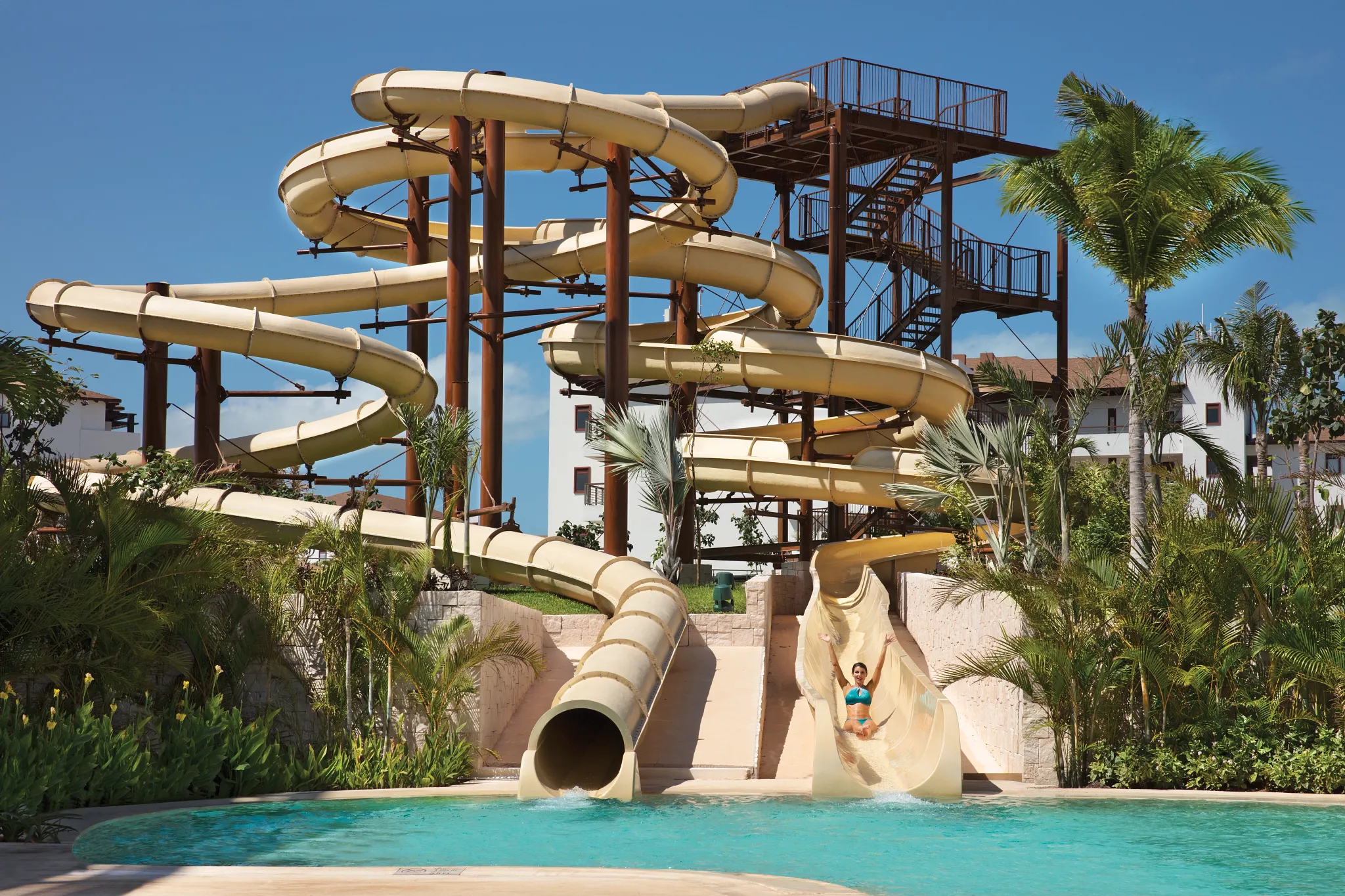 Large twisting water slides at Dreams Playa Mujeres Resort for family-friendly fun.